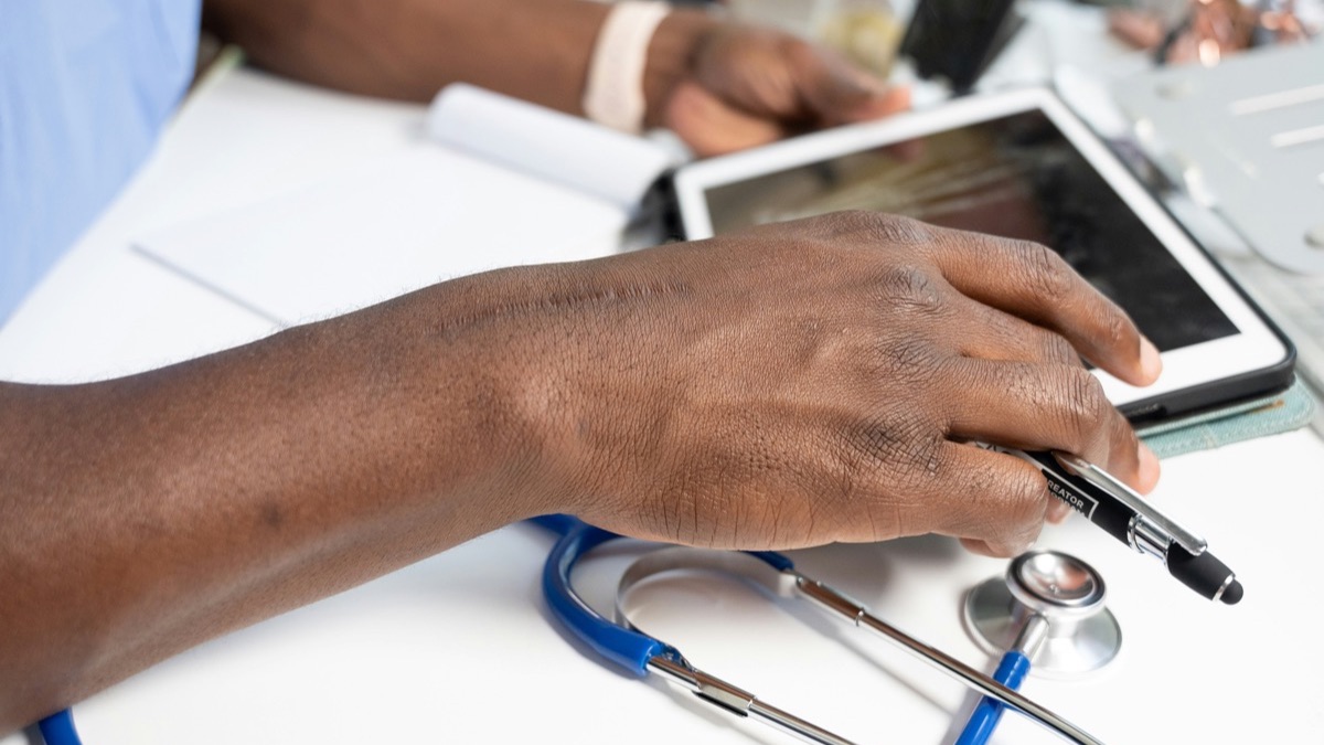 Person comparing health insurance documents after a job loss.